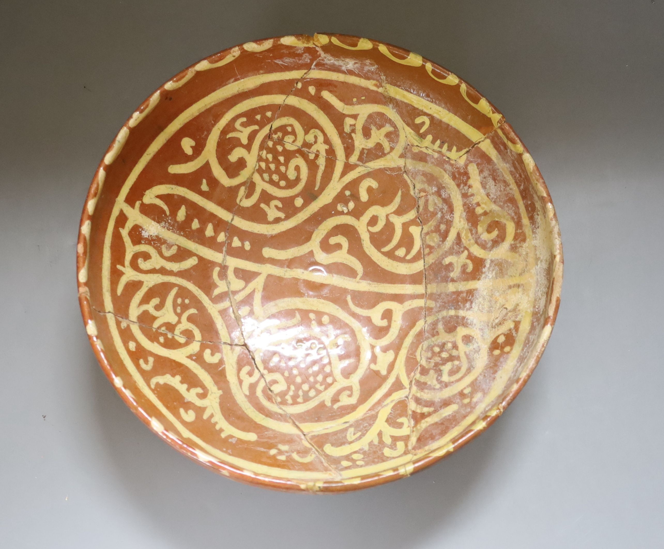 A Persian slipware bowl, circa 10th century, 24.5cm (a.f.)